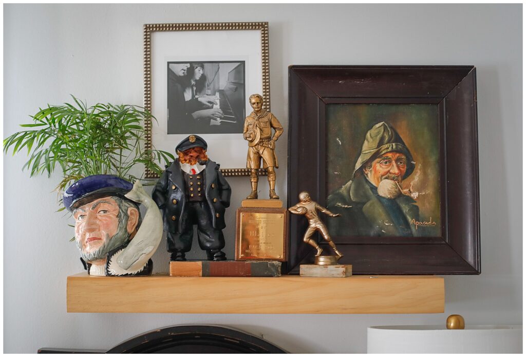 a collection of trophies and art on a boy's shelf.