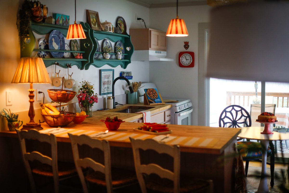 A picture of a kitchen with plates on the wall.